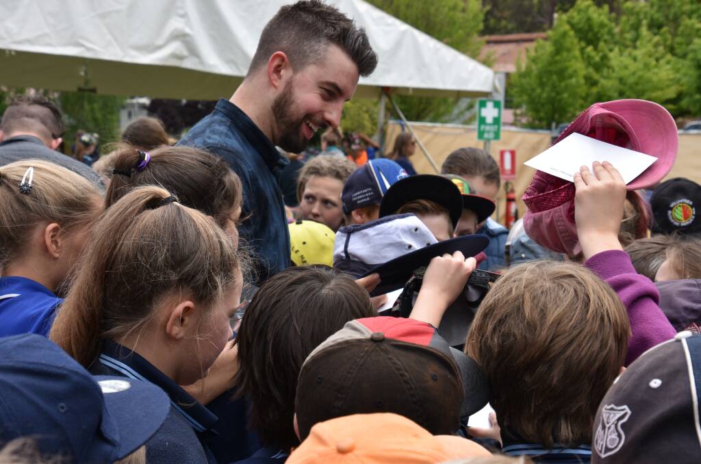 Festival faves: 19-Twenty front-man, Kane Dennelly, signs autographs for local school kids. Photo: Lee Steinbacher
