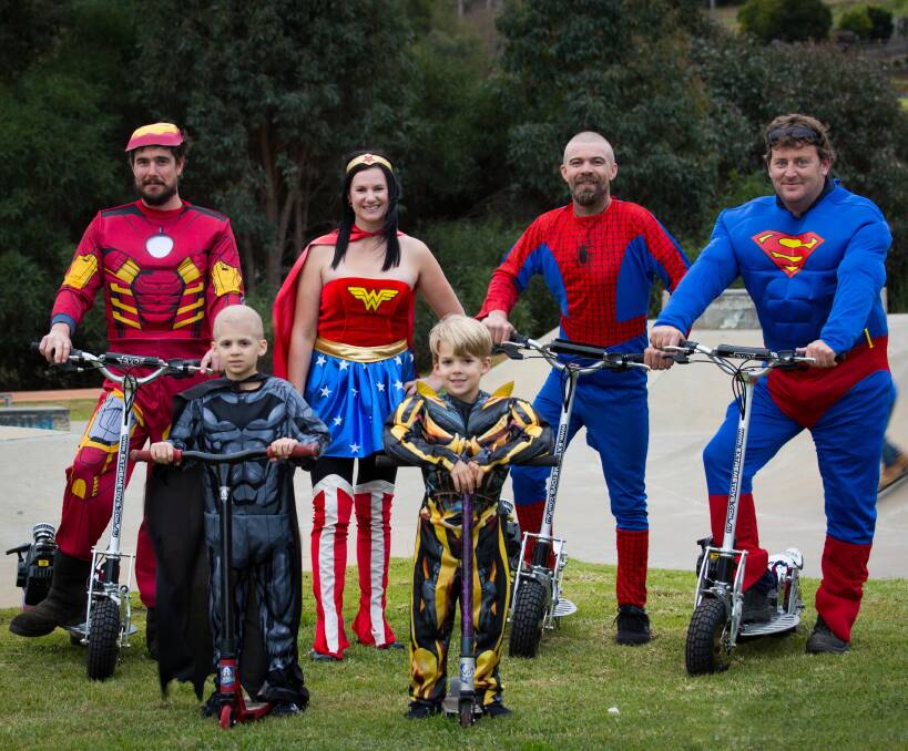 Super cool: Mathew Ralston (back left) and Warren Hancock (right) with the Kane family; Declan (7), Brodie (6), Kim and Simon, are raising awareness about childhood cancer. Photo: Victoria Baker