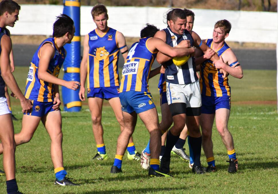Wrapped up: Kojonup's Matthew Mills struggling to break free of a Bridgetown tackle which was indicative of his team's afternoon on the park. Photo: Lee Steinbacher.