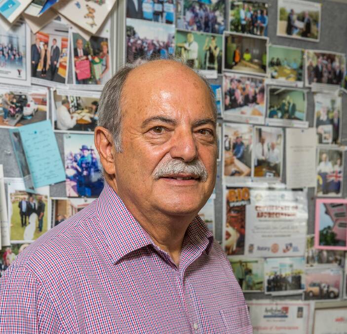 John Castrilli infront of his wall of certificates, photographs and thank you cards. Photo: Ashley Pearce.