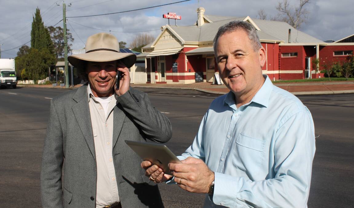 Realtor John Pitman will benefit from faster 4G in Kirup thanks to an upgrade in technology from Telstra. He is pictured with Telstra area general manager Boyd Brown. 