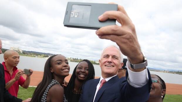 Prime Minister Malcolm Turnbull takes a selfie with new Australian citizens Lydia Banda-Mukuka and Chilandu Kalobi Chilaika. Photo: Andrew Meares