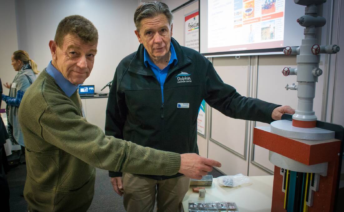 Not bore-ing: The Department of Minerals and Petroleum's Jeff Haworth and Bunbury Chamber of Commerce president David Kerr discuss well mechanics. Photo: JH
