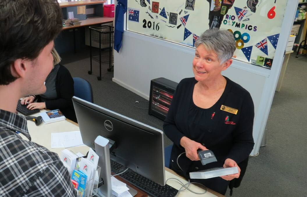 Book sharing: Donnybrook Community Library officer Margaret Evans serves a patron. Photo: Matthew Lau