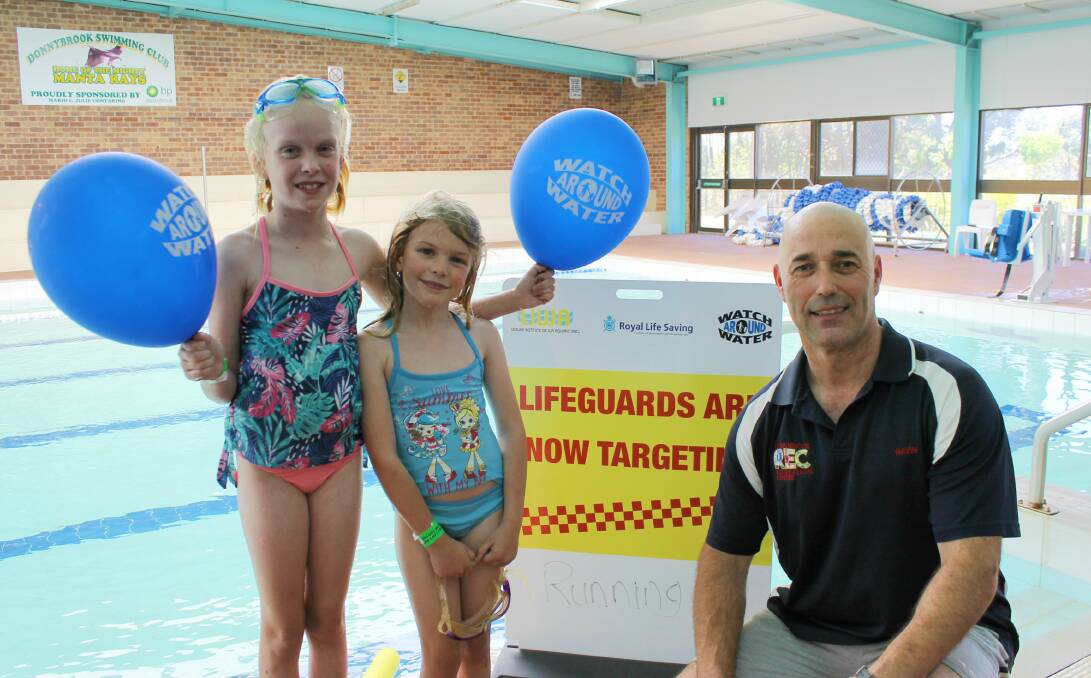 Watch Around Water: Madison and Chloe Dix with lifeguard Gavin Smith. Photo: Supplied