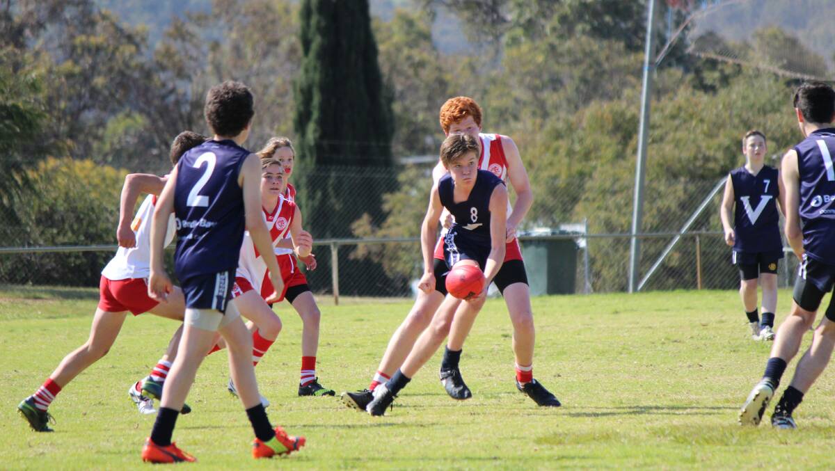 Young talent: Zac Trigwell gets the handball out. Photo: Supplied