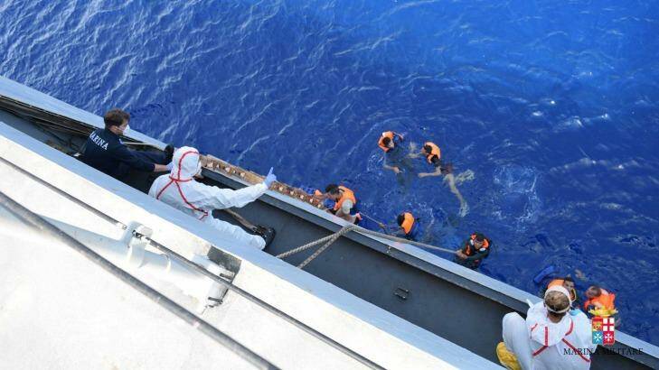 Some surviving migrants are pulled to safety.  Photo: Italian navy