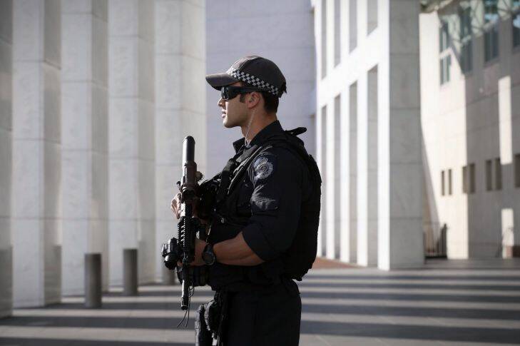 An AFP officer armed with an SR-16 stands guard to the front of Parliament House in Canberra on Thursday 23 October 2014. Photo: Andrew Meares
