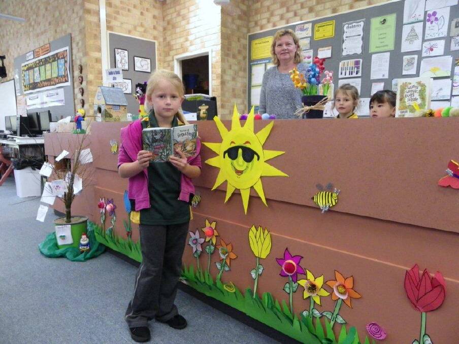 Reading time: School Librarian Angela Brimson with year one student Holly Tapper excited about a frog book.