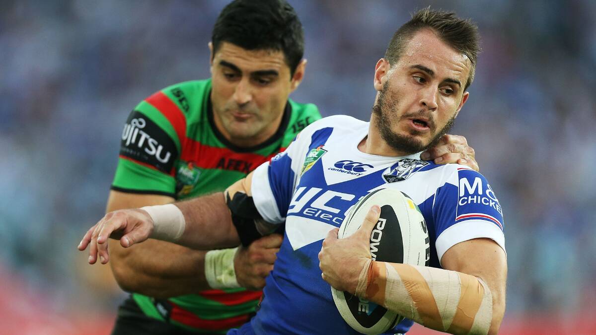 Josh Reynolds of the Bulldogs is tackled by Bryson Goodwin of the Rabbitohs during the round seven NRL match between the South Sydney Rabbitohs and the Canterbury-Bankstown Bulldogs at ANZ Stadium on April 18, 2014 in Sydney, Australia. Photo: Mark Metcalfe/Getty Images.