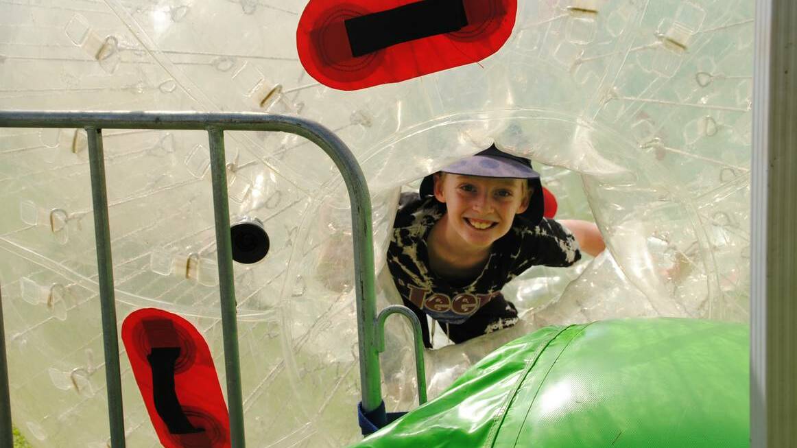 Raven Spencer-Smith checks out the Zorb Balls at the 2013 Donnybrook Apple Festival.