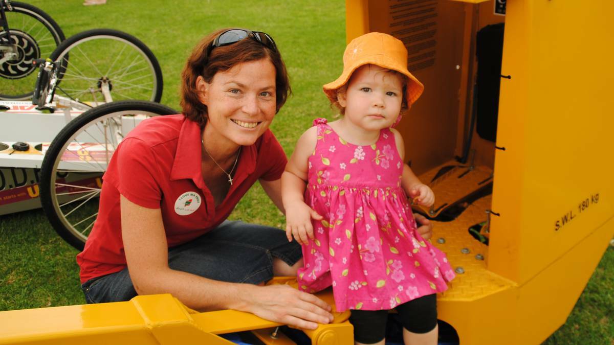 Emily Rae, 2, and Mum Shelley Rae check out some machinery in the produce tent at the 2013 Donnybrook Apple Festival.
