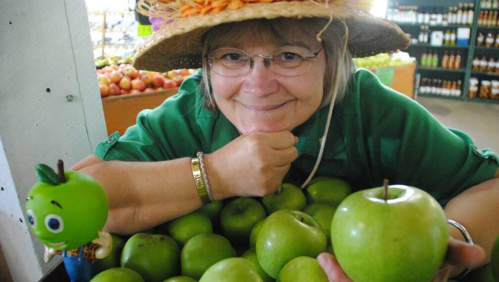 Granny (Lyn) Smith grabs a granny smith to take to the 2013 Donnybrook Apple Festival.