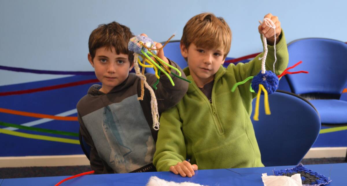 Lynus Butler and his friend Patrick Butler make knitted neurons at the Greenbushes CRC which will form part of a national “brain” display for Science Week in August. 