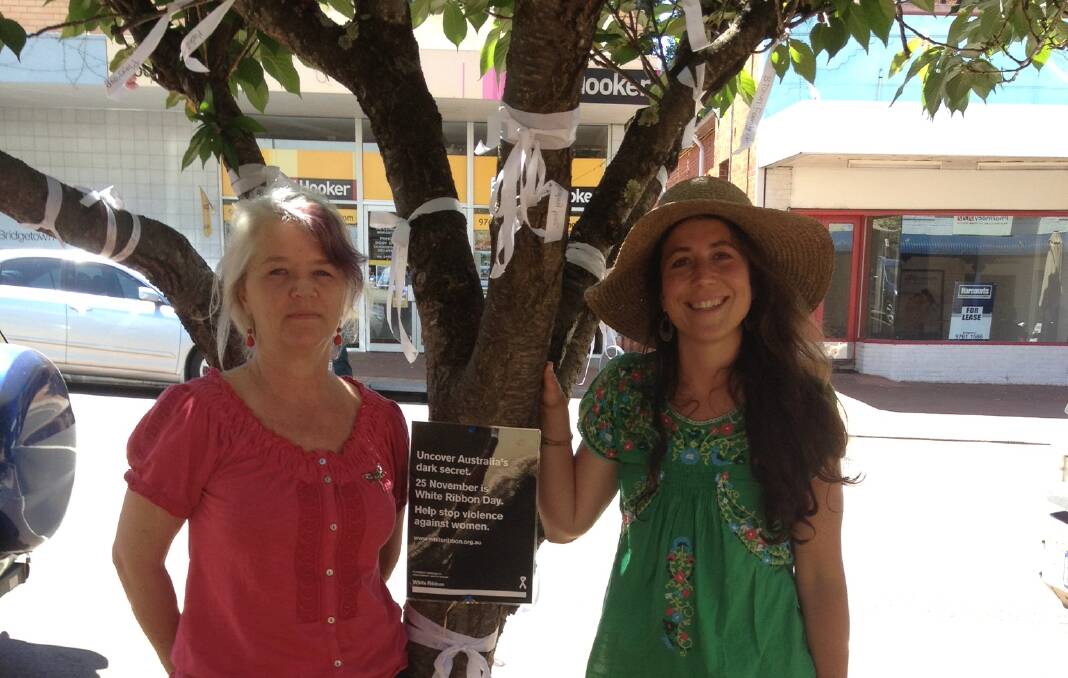 Kath Bell and Rae Smith show the white ribbons on a tree in Bridgetown. 