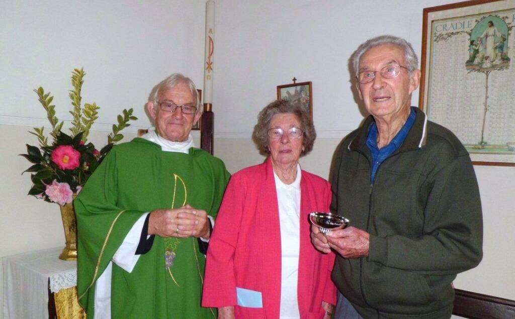 Officiating at a service, Cannon George Harvey with Mary and Jack Kitchen holding the intinction chalice that had been donated by the family and on which is inscribed “To the Greater Glory of God” on one side, with “a gift to St George’s Church from Jack and Mary Kitchen” on the other side. 