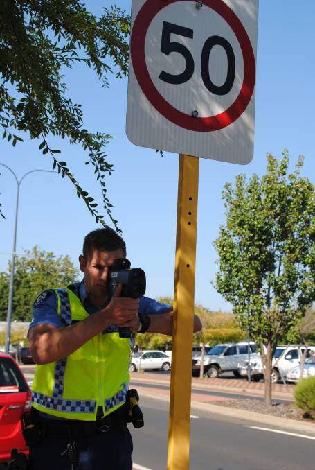 Slow down: First Class Constable Adam Stratton puts the focus on drivers in the main street of Donnybrook. 