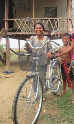 Smiles: Danan of Cambodia shows her delight at receiving a bicycle, which will mean she can graduate to secondary school. 