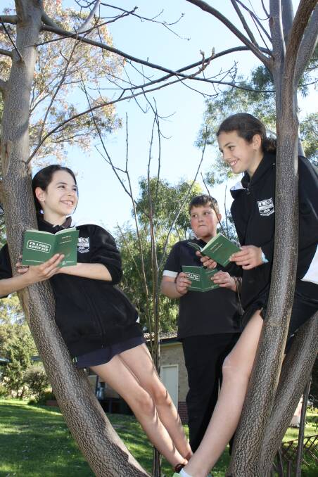 Balingup Primary School students Yali Harris, Rhylie Scarrott and Stephanie Aldridge check out their NaturePlay passports. 
