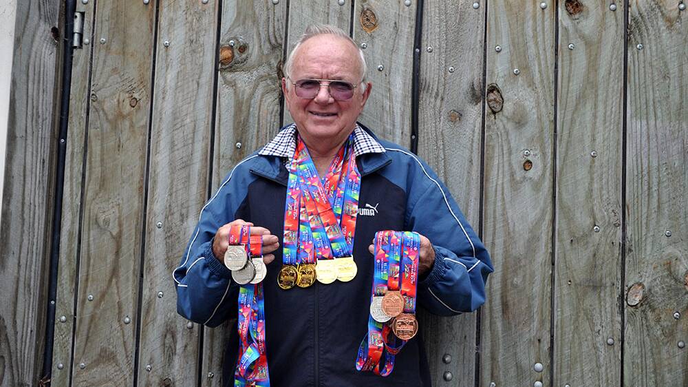 Proud: Robert Doust holds all his medals from the 2014 games. 
