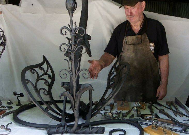 Brian Golding shows off the beautifully crafted dragon made in the forge. 