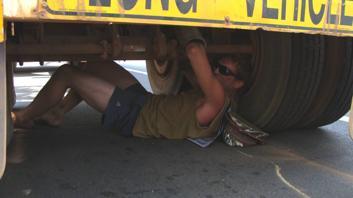A protester chained underneath a log truck in Bridgetown during a 2012 protest in Bridgetown. These tactics are illegal under new state legislation. 