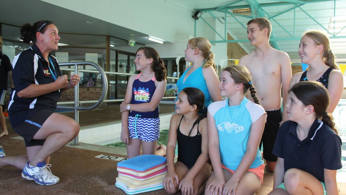 Instructor Sally Baker gets set for a swim club session with club members. 