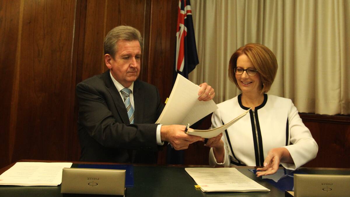 NSW Premier Barry O'Farrell swaps papers with then Prime Minister Julia Gillard as he signs on to the Gonski Funding Model, making NSW the first state to do so. Picture: Dominic Lorrimer