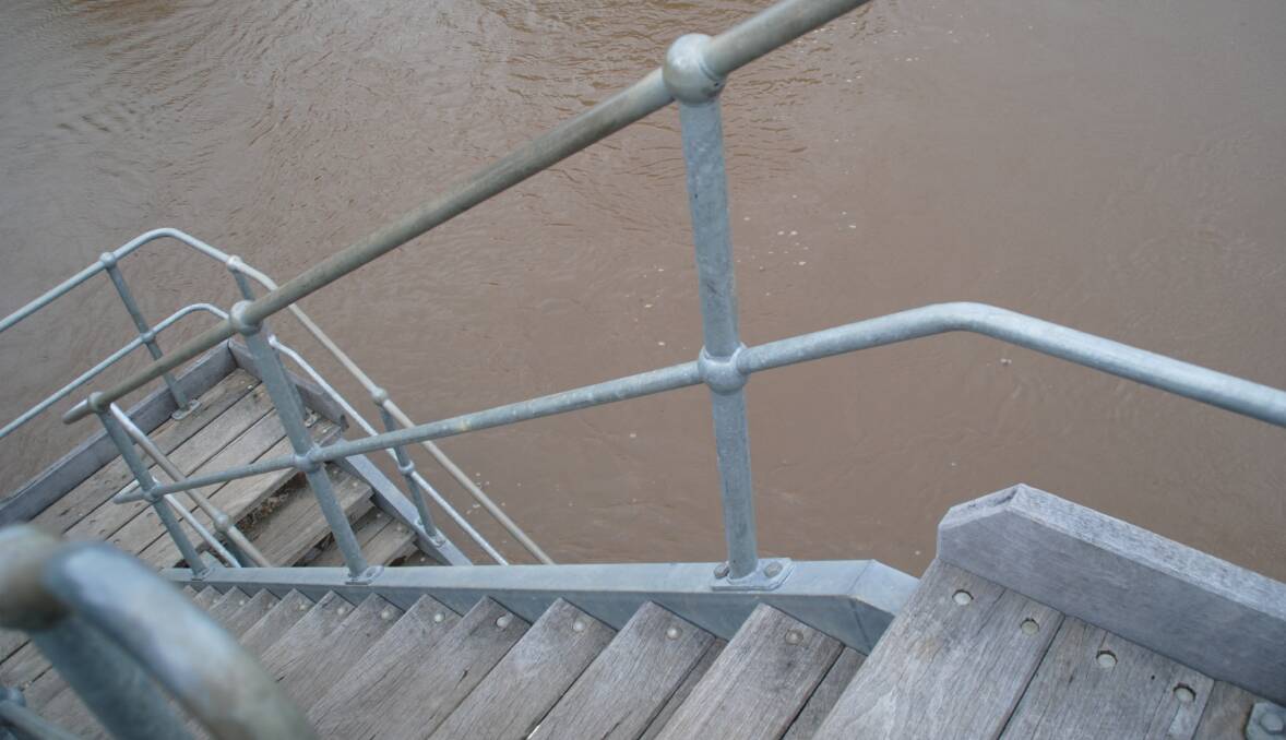 The stairs of the Preston River footbridge lead to deep water.