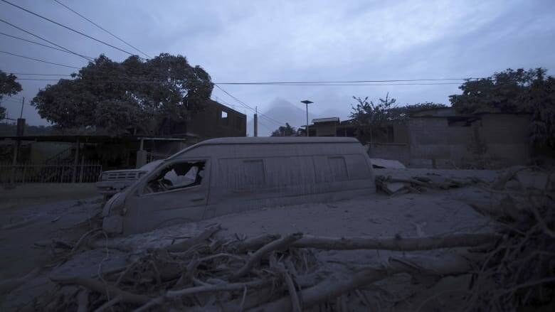 A vehicle sits partially buried in volcanic ash spewed by the Volcan de Fuego. Photo: AP