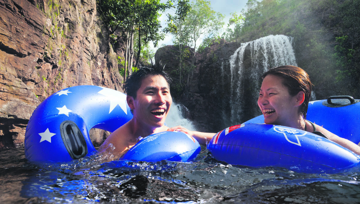 Visitors go for a dip at Florence Falls in Litchfield National Park in the Northern Territory..
