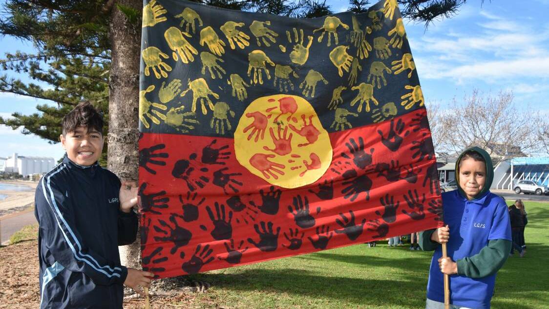 PORT LINCOLN: Lincoln Gardens Primary School students Wesley Bilney and Jyezaiah Cook with a banner the school used in the NAIDOC Week March.