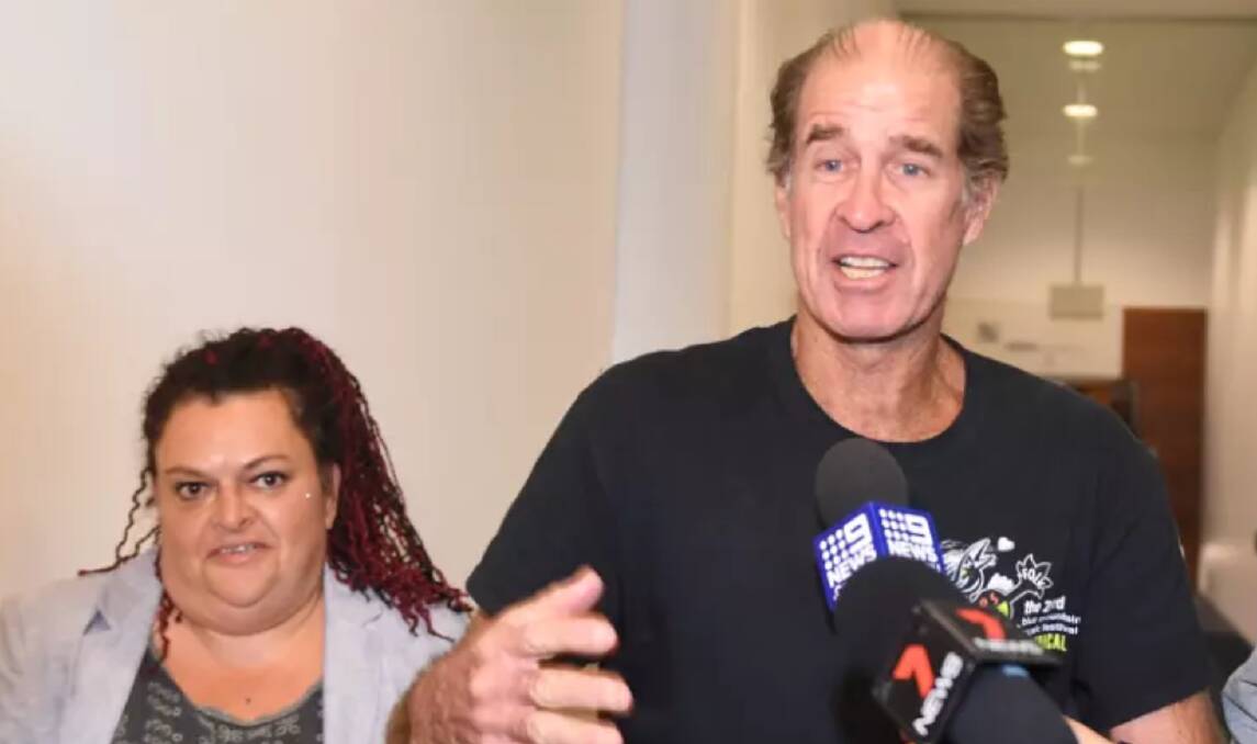 Australian filmmaker James Ricketson (centre), with his daughter Roxanne Holmes (left), arrives at Sydney International Airport. Photo: AAP

