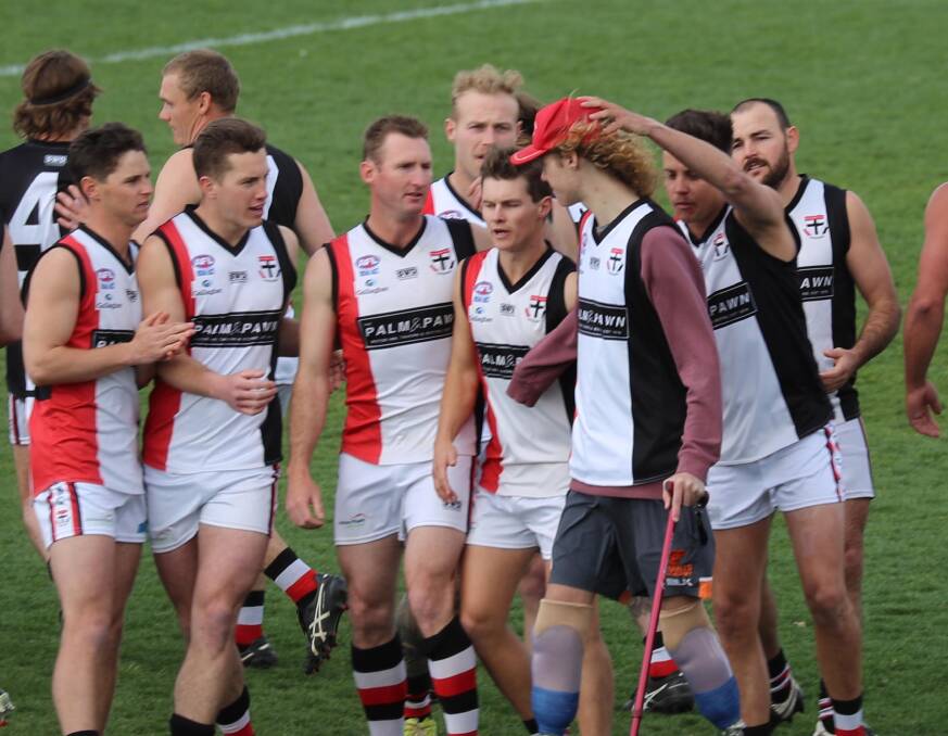 INSPIRATION: The Saints get around their teammate before last year's Farrer League grand final. Picture: Les Smith