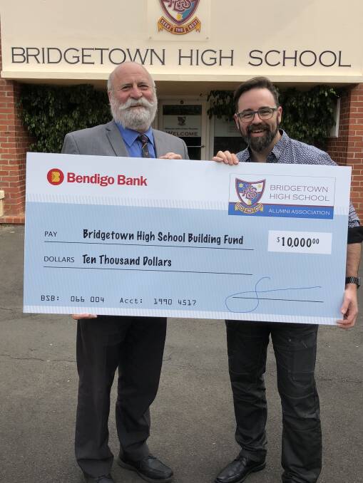 Fundraising: Bridgetown High School principal Stephen Bullied accepts a cheque from Bridgetown High School Alumni chair Scott Robinson. Photo: Supplied.