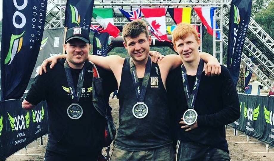 Ty Howlett with Australian Adaptive OCR teammate Mark Daniels and Owen Daniels after the 24-hour Enduro Obstacle Course Racing World Championships. Photo: supplied