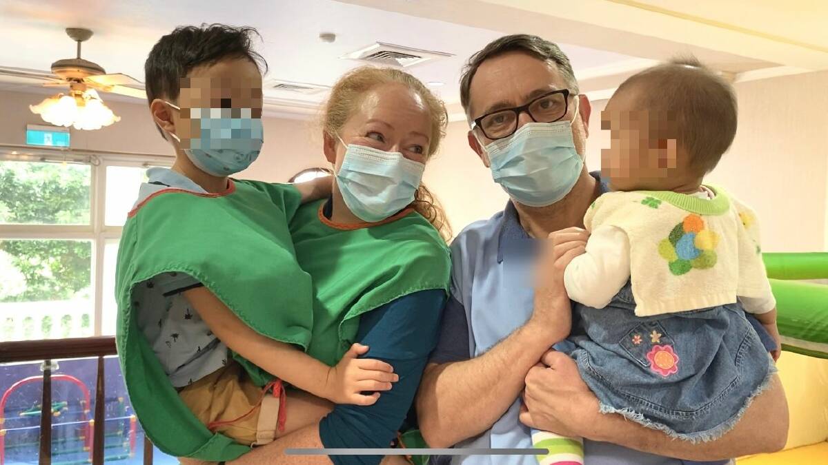 Fiona and Charles with their son the moment they met their new daughter in Taiwan.