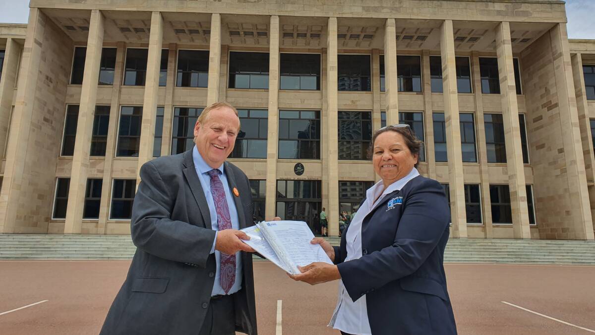 Bunbury MLA Don Punch with South West Aboriginal Medical Service chief executive Lesley Nelson with the petition for Parliament. Photo is supplied.