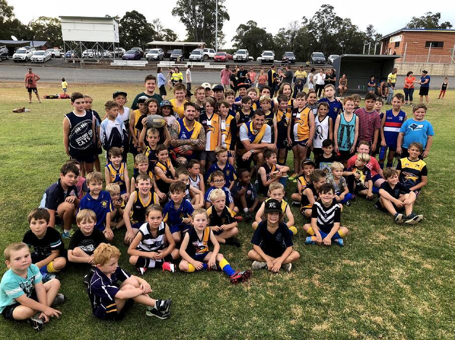 WITH THEIR IDOLS: Bridgetown's Auskick players celebrate a day out with Dane Swan and Glen Jakovich. Photo: Lee Steinbacher.