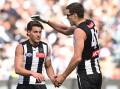 Magpie Mason Cox (right) congratulates Patrick Lipinski on one of his four goals against Port. (James Ross/AAP PHOTOS)