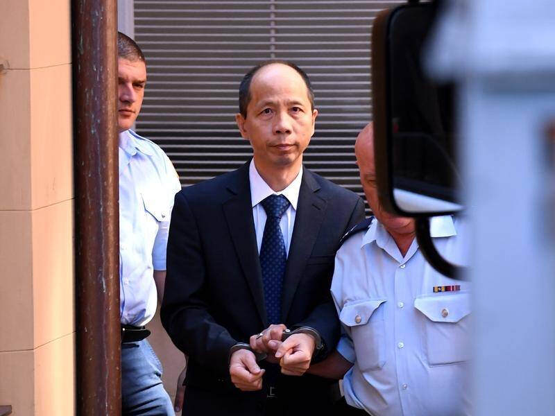 Robert Xie (centre) was given five life sentences for the murder of five relatives.