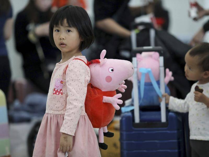 A Chinese girl carries a Peppa Pig-shaped bag in the city of Shenzen, south China.