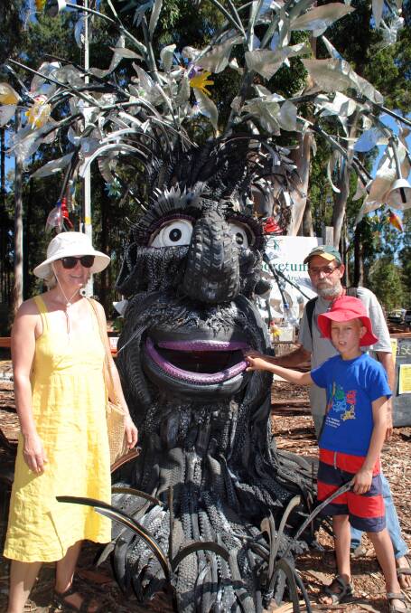 Ursula, Raymond and Kieran Gibson with the Tyrone Treadbark sculpture.