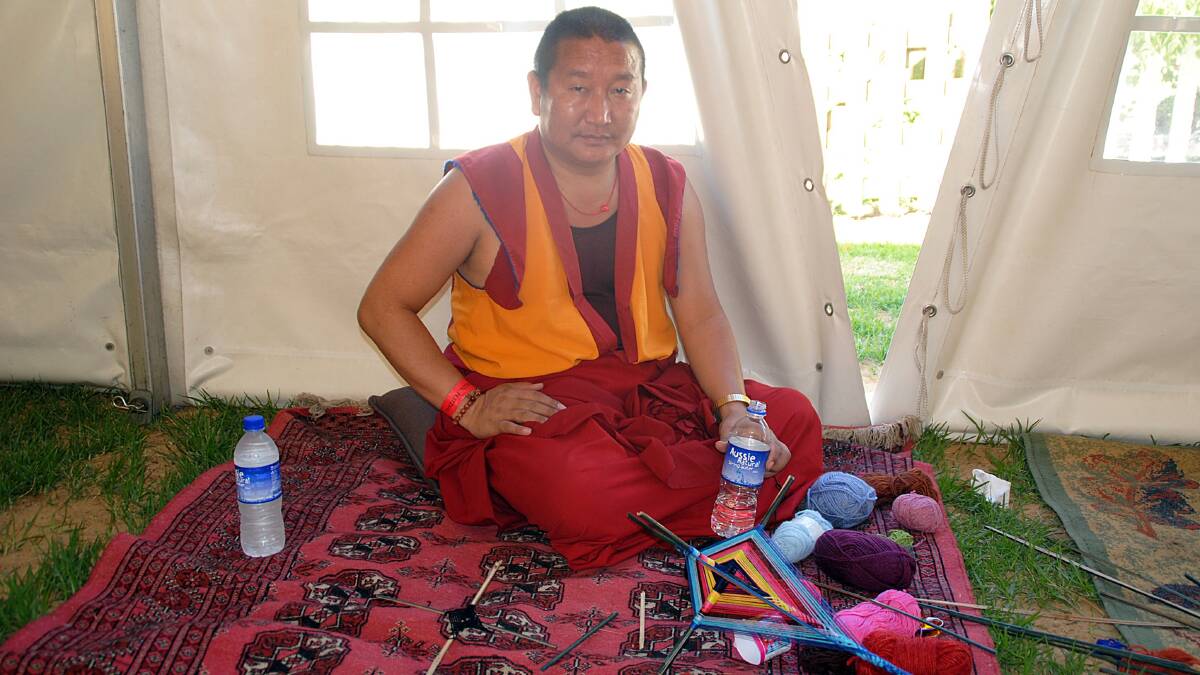 Tibetan Buddhist Monk Lobsang retreats from the heat.