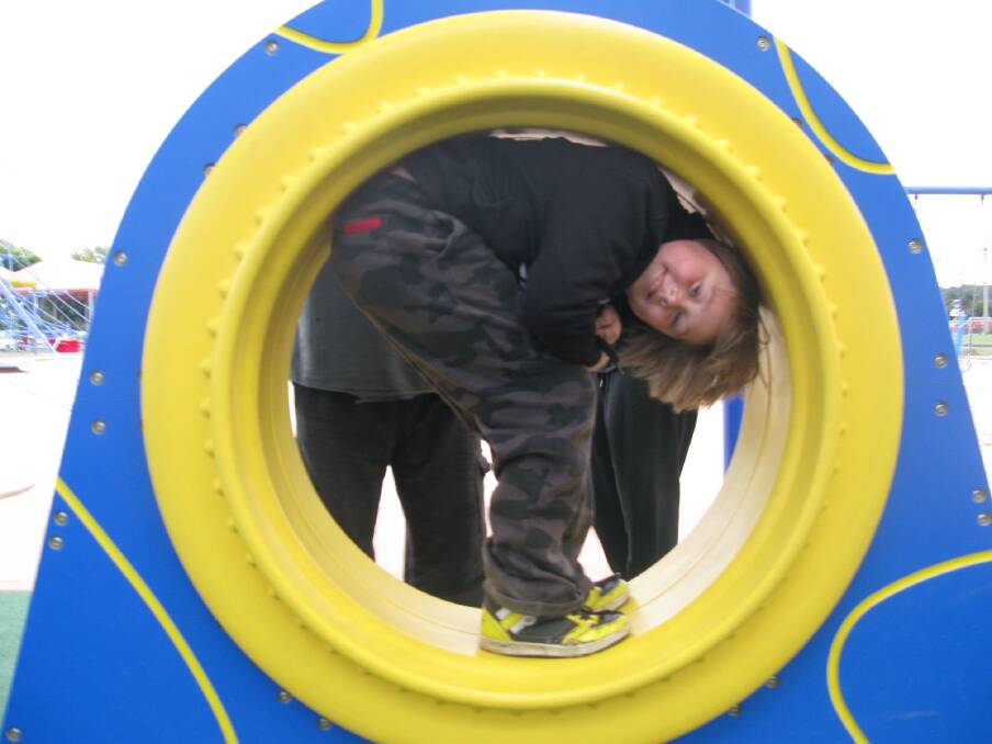  Quick spin: Kayne O'Dine, 10, takes a spin on some of the Apple FunPark play equipment.